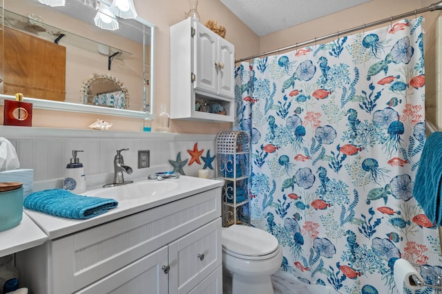 bathroom featuring a textured ceiling, toilet, decorative backsplash, and vanity