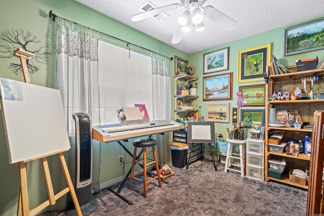 carpeted office with ceiling fan and a textured ceiling