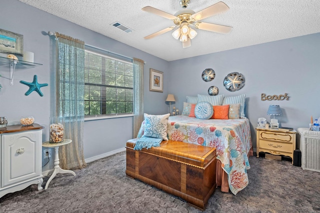 carpeted bedroom featuring ceiling fan and a textured ceiling