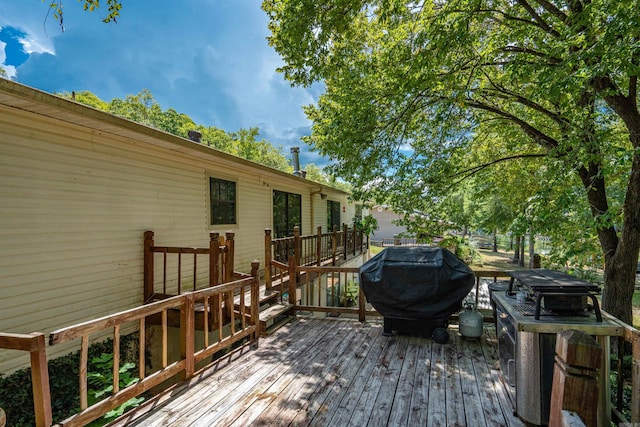 wooden terrace with a grill