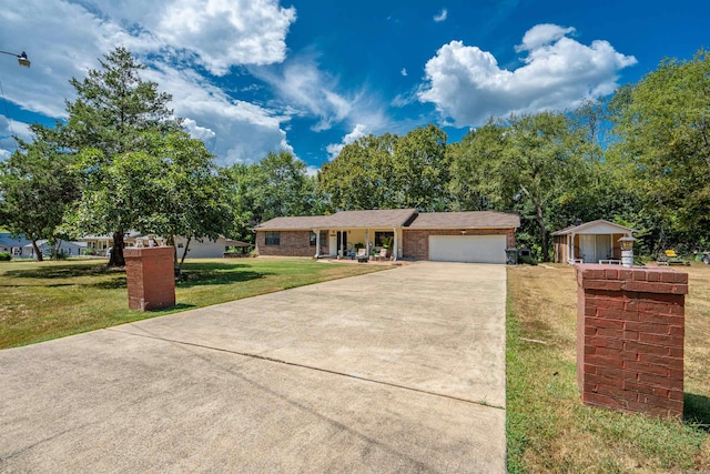 ranch-style home featuring a garage and a front lawn