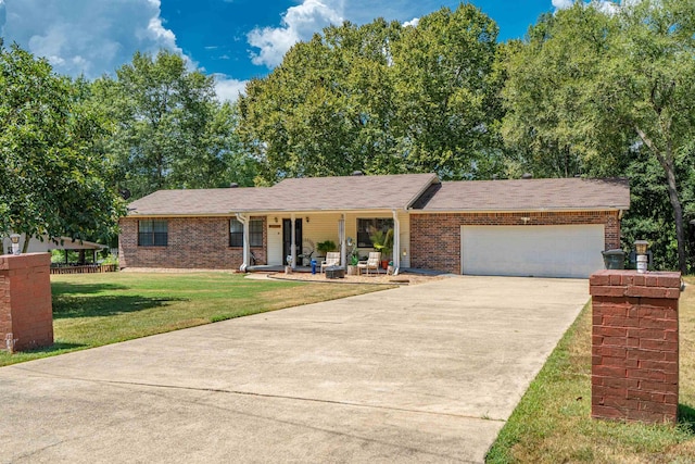 ranch-style house featuring a front lawn, a porch, and a garage