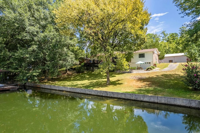 exterior space featuring a water view and a yard