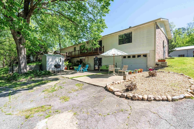 rear view of property with a patio area and a garage