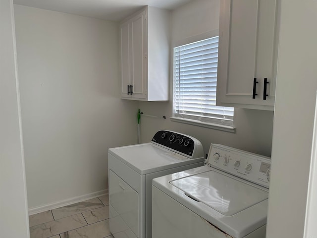 laundry room featuring light tile patterned floors, cabinets, and washing machine and clothes dryer