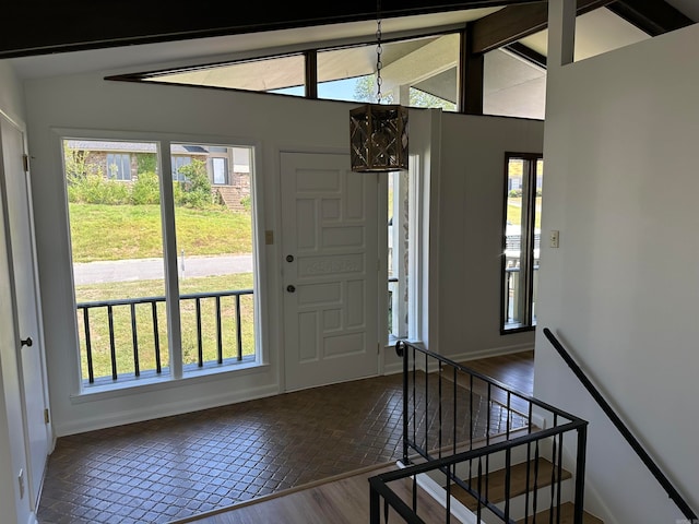 entryway featuring a wealth of natural light, vaulted ceiling, and hardwood / wood-style flooring