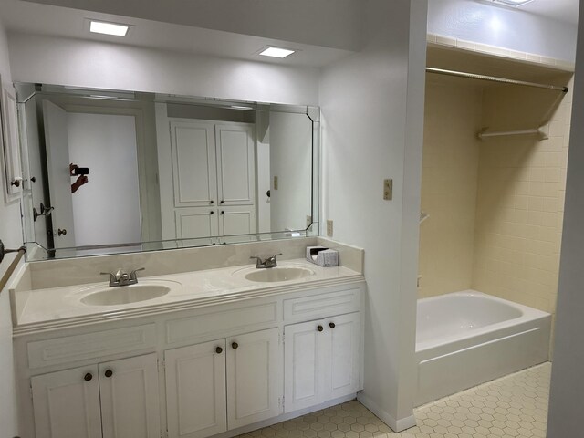 bathroom featuring dual vanity, shower / washtub combination, and tile patterned floors