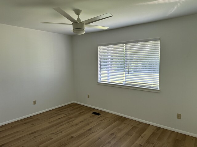 spare room with ceiling fan and wood-type flooring