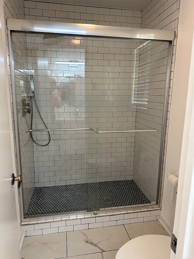 bathroom with toilet and walk in shower