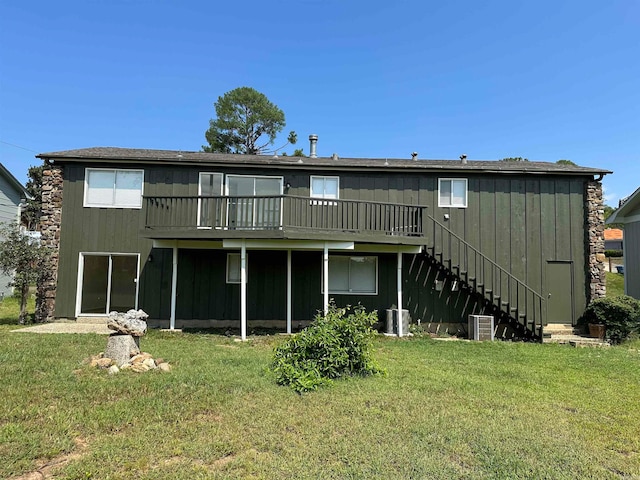 rear view of house featuring a yard and central AC unit