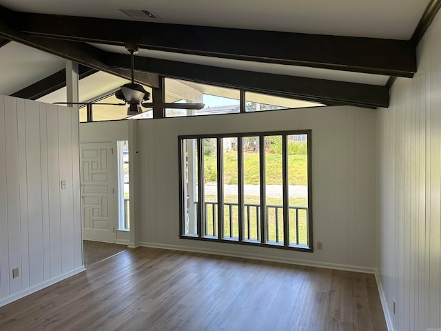 unfurnished room with beamed ceiling, hardwood / wood-style flooring, plenty of natural light, and high vaulted ceiling