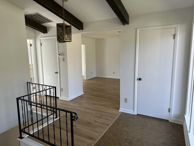 interior space with hardwood / wood-style floors and beamed ceiling