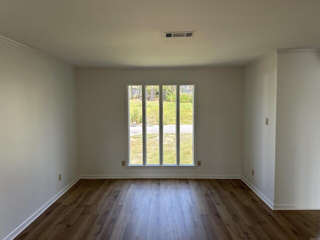 unfurnished room featuring a wealth of natural light, dark hardwood / wood-style floors, and ornamental molding