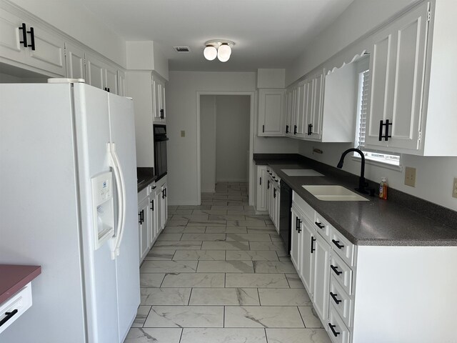 kitchen with sink, white cabinetry, light tile patterned floors, and black appliances