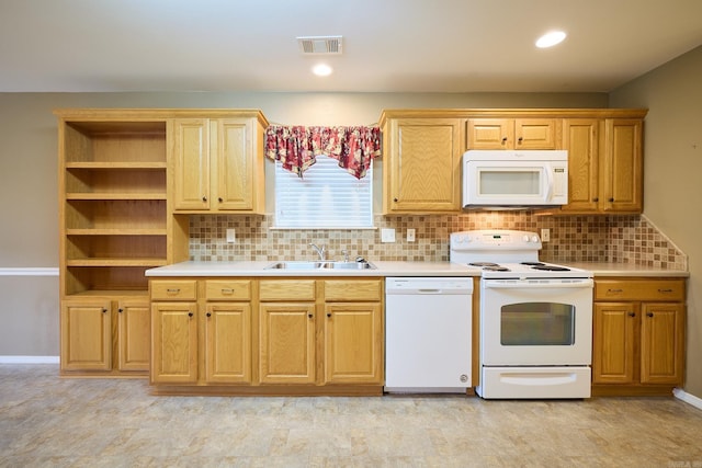 kitchen with decorative backsplash, white appliances, and sink