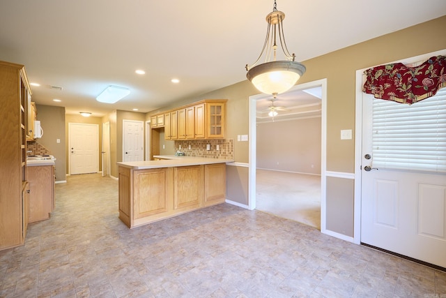 kitchen featuring pendant lighting, light brown cabinets, backsplash, ceiling fan, and kitchen peninsula