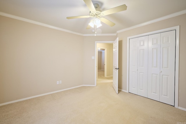 unfurnished bedroom featuring a closet, ceiling fan, crown molding, and light carpet