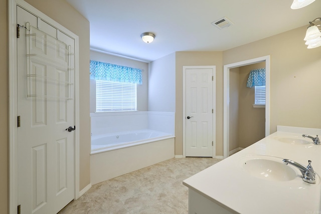 bathroom featuring a tub to relax in and vanity