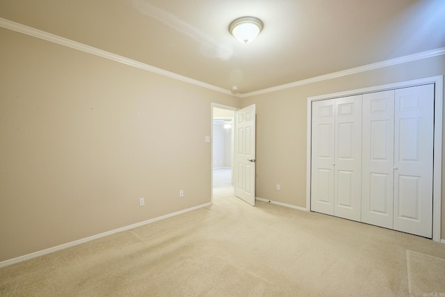 unfurnished bedroom with ornamental molding, light carpet, and a closet