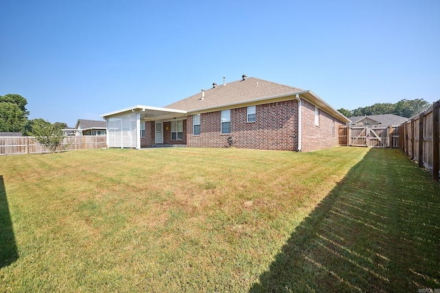 rear view of house with a yard