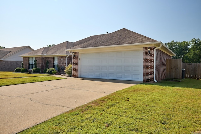 ranch-style home with a garage and a front lawn