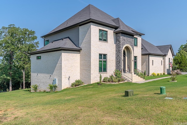 french country style house featuring a front lawn