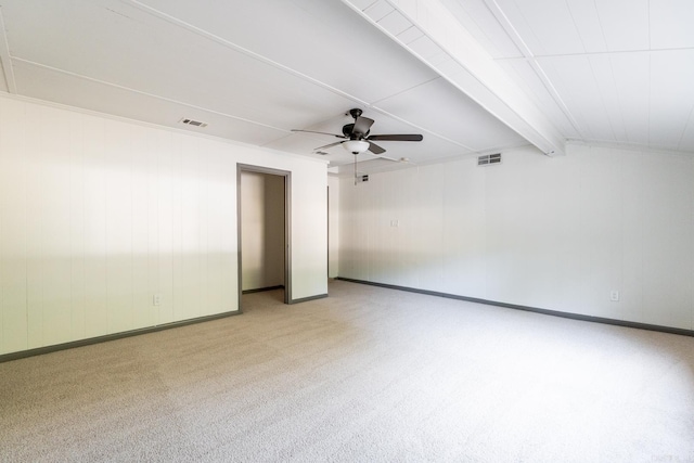 unfurnished room featuring ceiling fan, beamed ceiling, and light carpet