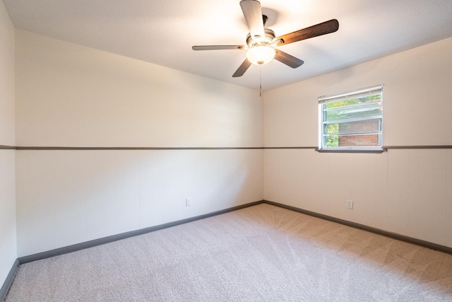 unfurnished room with ceiling fan and light colored carpet