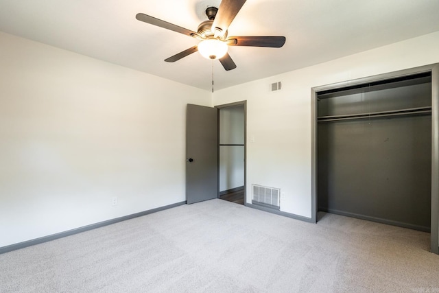 unfurnished bedroom featuring ceiling fan, a closet, and carpet floors