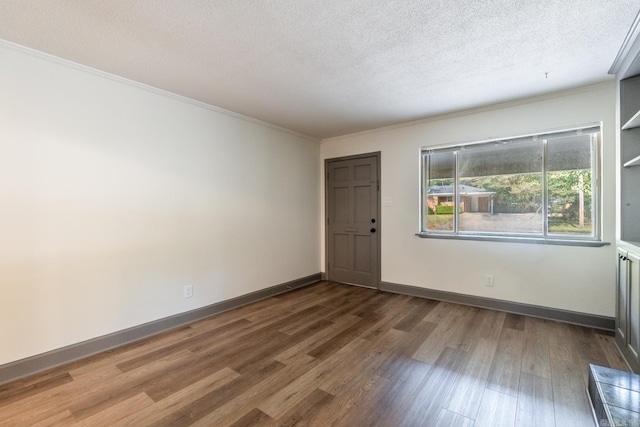 foyer entrance with a textured ceiling, crown molding, and hardwood / wood-style flooring