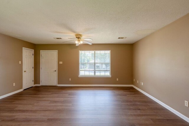 spare room featuring ceiling fan, wood-type flooring, and a textured ceiling