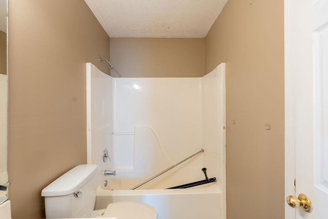 bathroom featuring a textured ceiling, toilet, and shower / tub combination