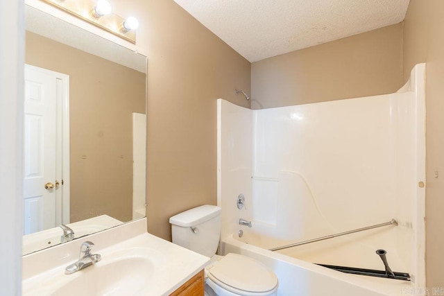 full bathroom with shower / bath combination, vanity, toilet, and a textured ceiling