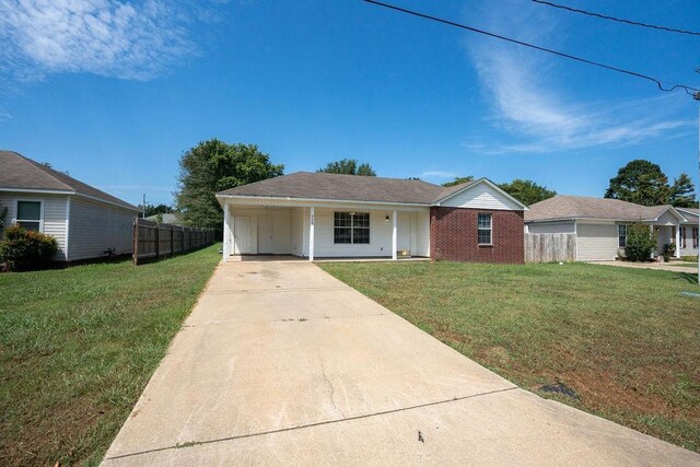 single story home featuring a carport and a front lawn