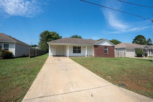 ranch-style home featuring a carport and a front yard