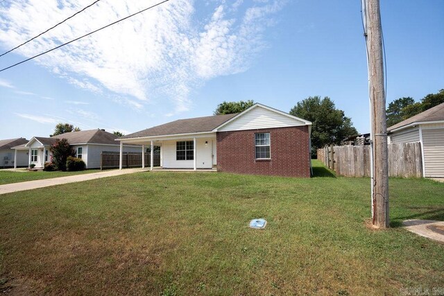 single story home featuring a front yard and a carport