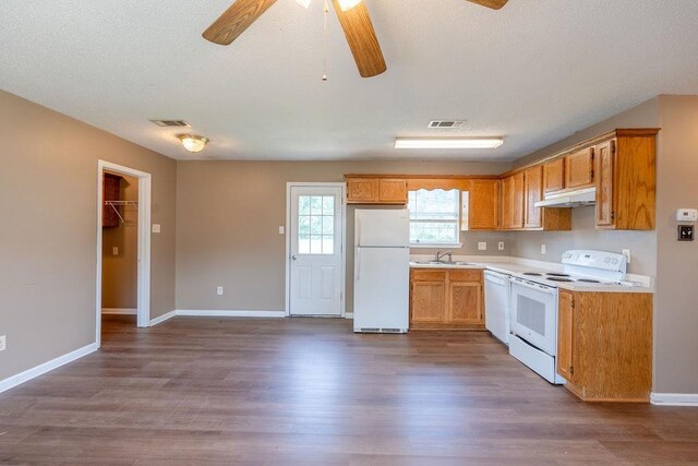 kitchen with white appliances, ceiling fan, and dark hardwood / wood-style flooring