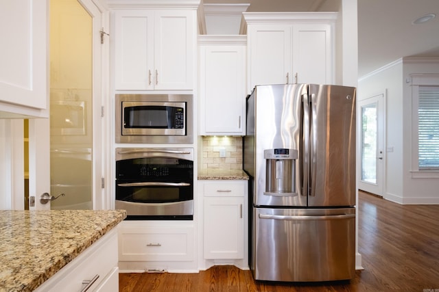 kitchen featuring ornamental molding, dark wood-type flooring, tasteful backsplash, and stainless steel appliances