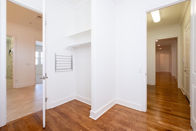 corridor with crown molding and hardwood / wood-style floors