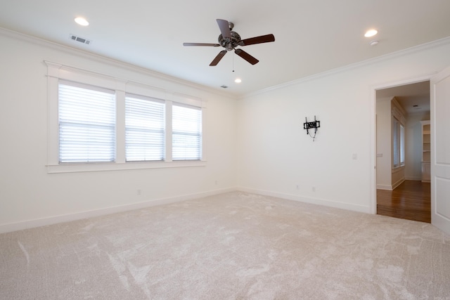 carpeted empty room featuring ceiling fan and ornamental molding