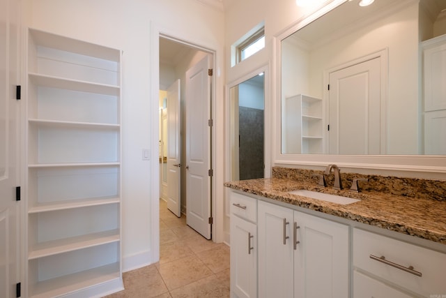 bathroom featuring tile patterned floors, ornamental molding, and vanity