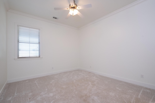 spare room with ceiling fan, carpet floors, and crown molding