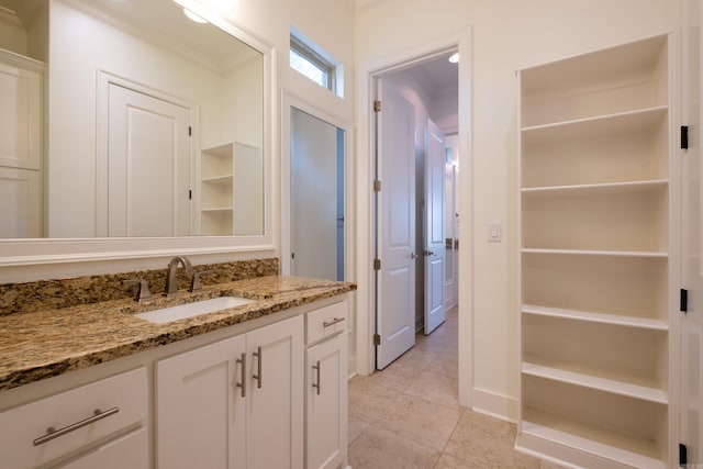 bathroom featuring crown molding, vanity, and tile patterned floors