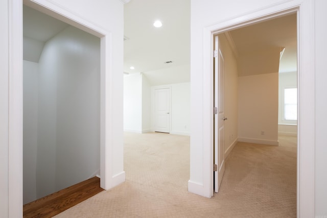 hall with light colored carpet