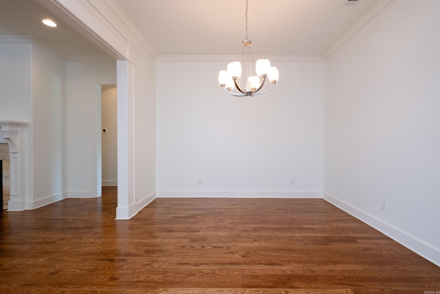 unfurnished dining area featuring ornamental molding, an inviting chandelier, and hardwood / wood-style flooring