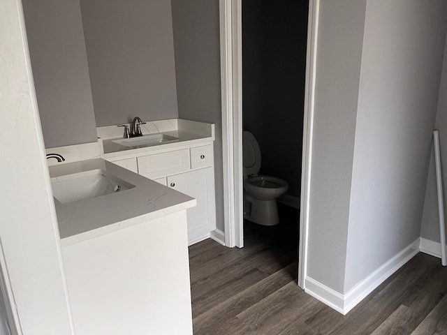 bathroom featuring hardwood / wood-style floors, toilet, and vanity