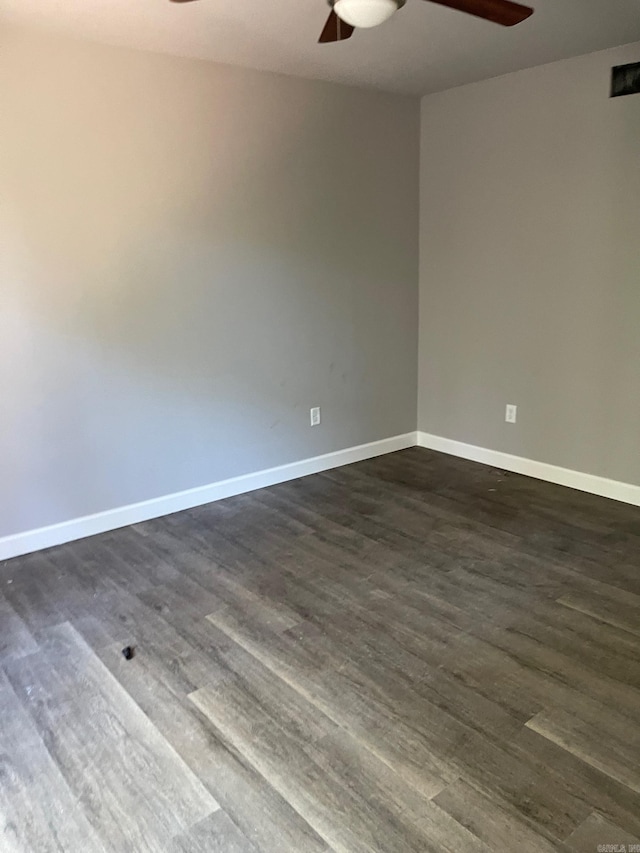 spare room with ceiling fan and dark hardwood / wood-style floors