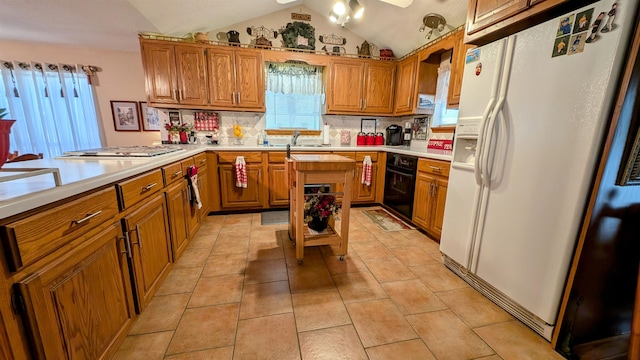 kitchen with light tile patterned floors, vaulted ceiling, decorative backsplash, and white refrigerator with ice dispenser