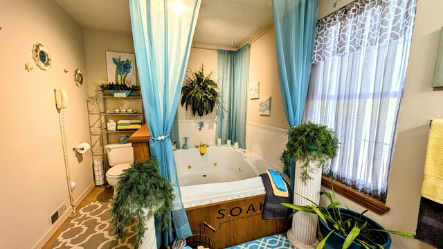 bathroom featuring a textured ceiling and toilet