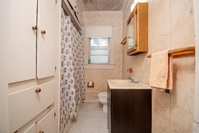 bathroom featuring toilet, tile patterned flooring, vanity, tile walls, and crown molding